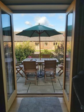 Double doors leading out of living room onto garden patio