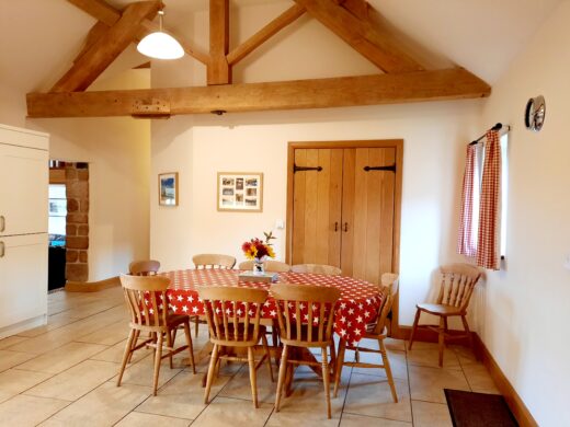 spacious kitchen area with exposed beams