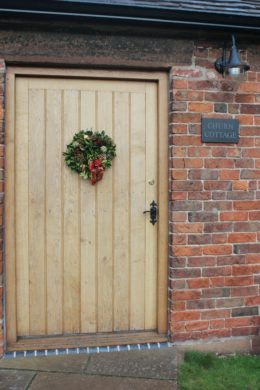 front door with Christmas wreath churn cottage