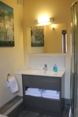 sink unit with fluffy towels and large mirror